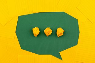 Abstract image of paper notes and crumpled paper balls symbolising confusion and the need for clear communication
