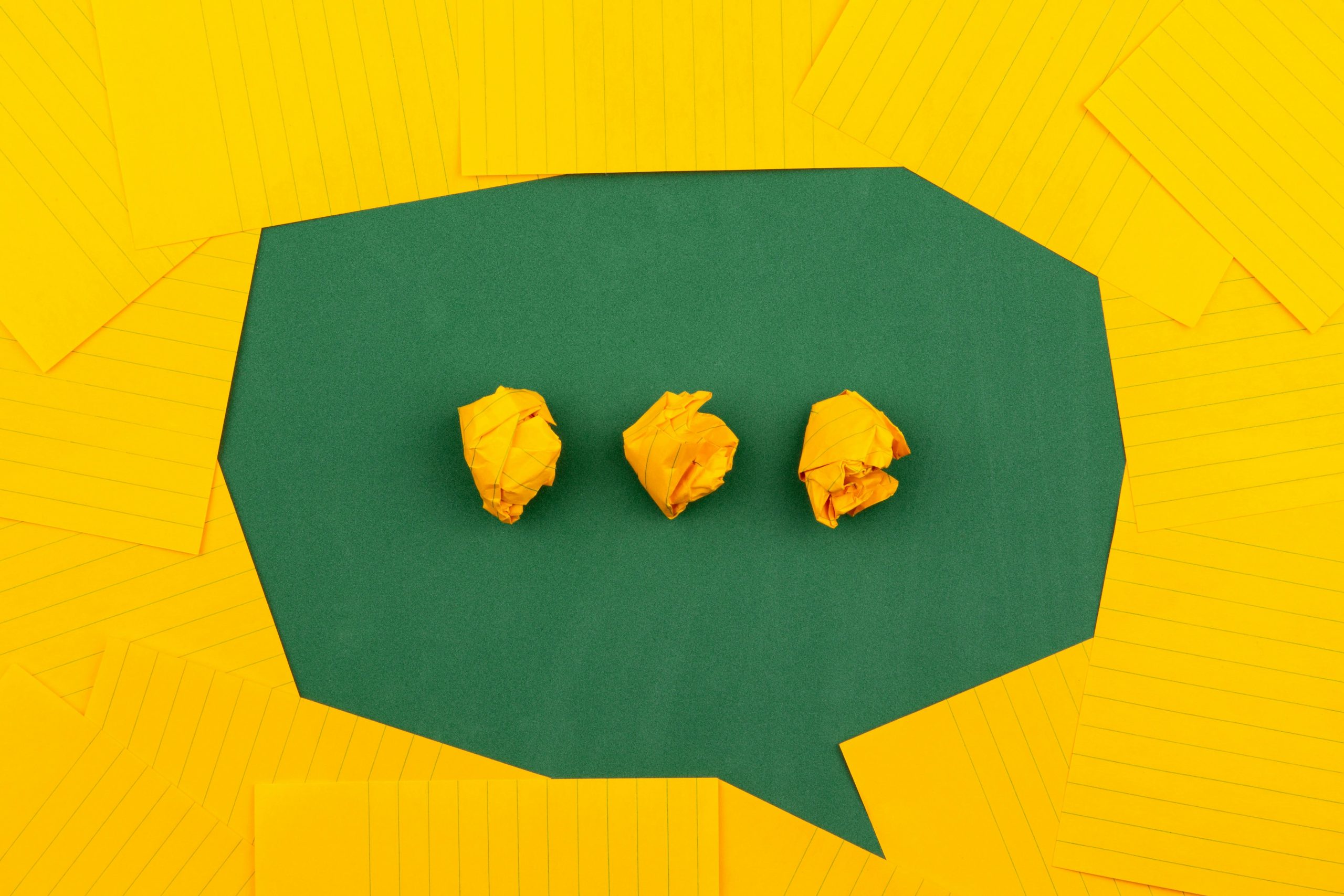 Abstract image of paper notes and crumpled paper balls symbolising confusion and the need for clear communication